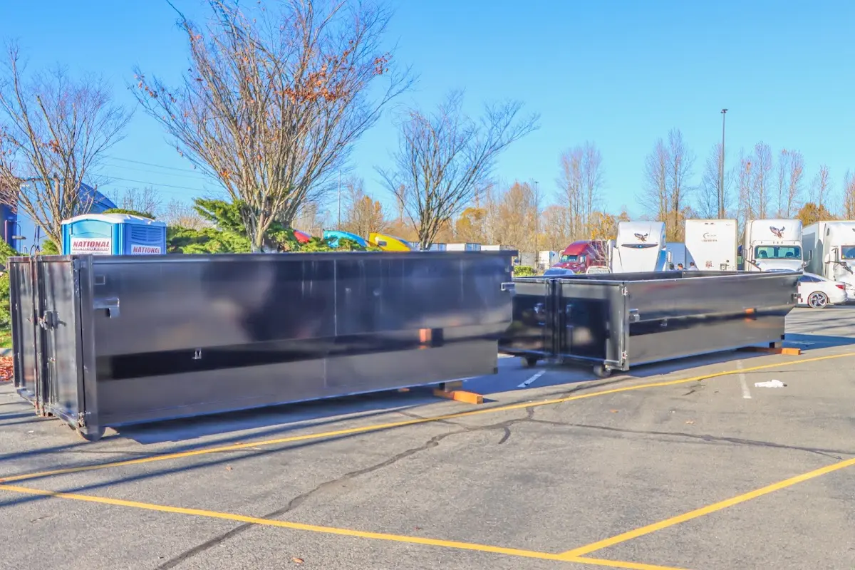 Professional dumpster rental service with roll-off container on residential driveway in Thatcher